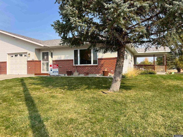 single story home with a front yard and a garage