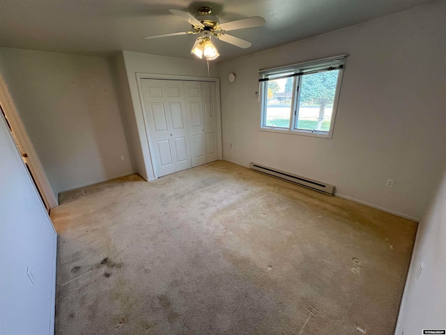 unfurnished bedroom with a closet, ceiling fan, light colored carpet, and a baseboard radiator