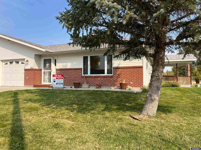 ranch-style home with a front lawn and a garage