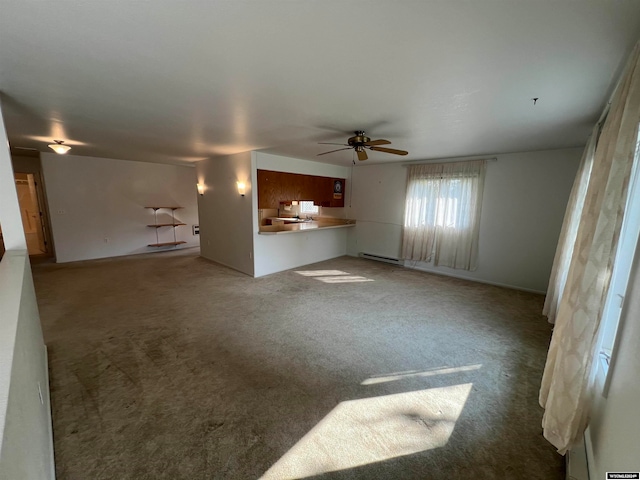 unfurnished living room with carpet floors, ceiling fan, and a baseboard radiator