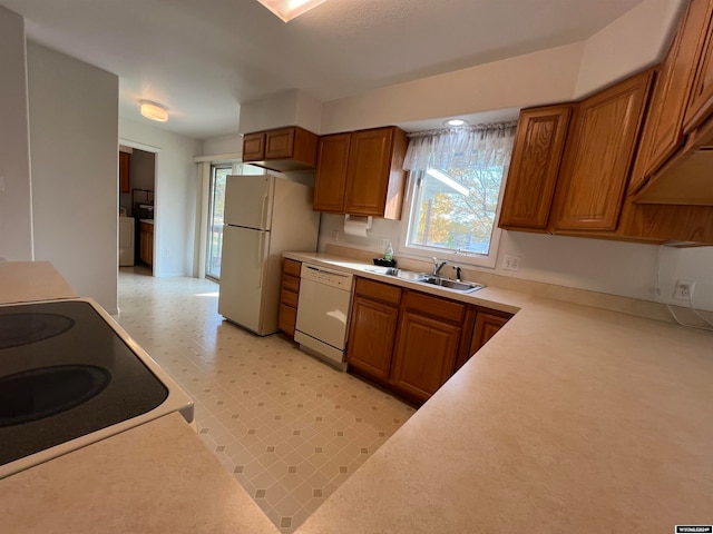 kitchen with white appliances, sink, and washer / clothes dryer