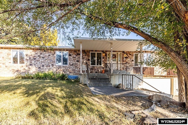 single story home featuring a garage and a front yard