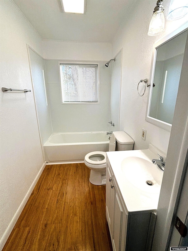 full bathroom with washtub / shower combination, wood-type flooring, vanity, and toilet