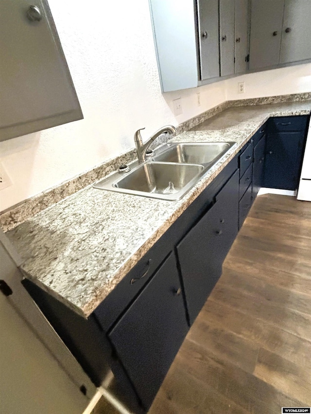 kitchen with dark hardwood / wood-style flooring and sink