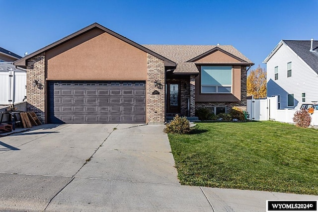 view of front of property with a front lawn and a garage