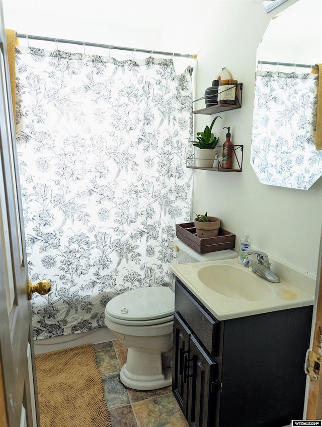 full bathroom with vanity, shower / bath combo with shower curtain, and toilet