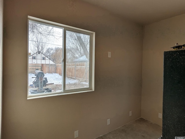 spare room featuring plenty of natural light and concrete floors