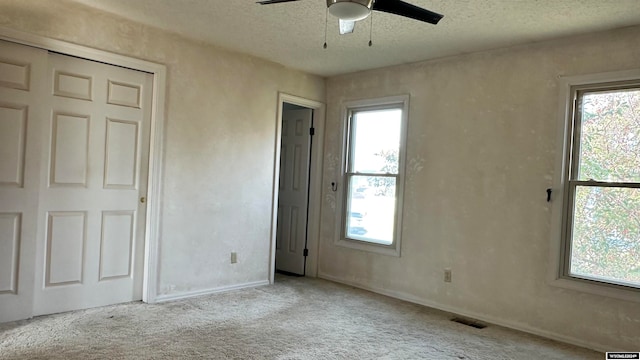 unfurnished bedroom with multiple windows and light colored carpet