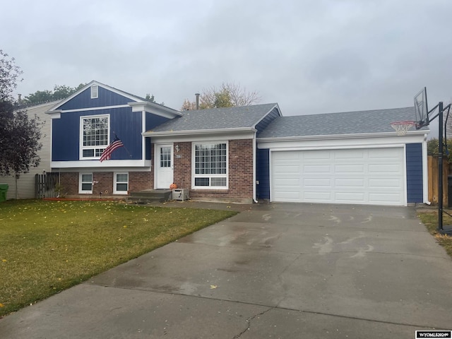 split level home with a garage and a front lawn