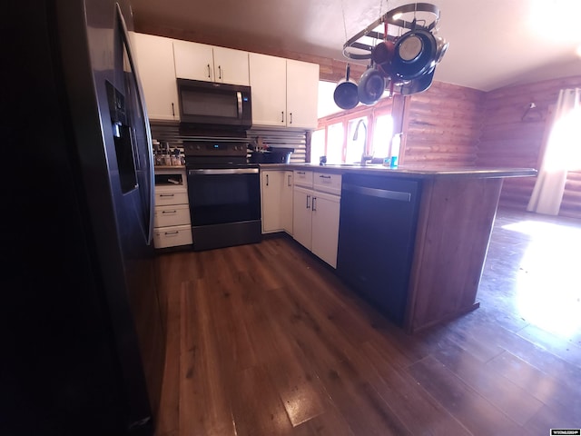 kitchen with kitchen peninsula, tasteful backsplash, white cabinetry, dark hardwood / wood-style floors, and black appliances