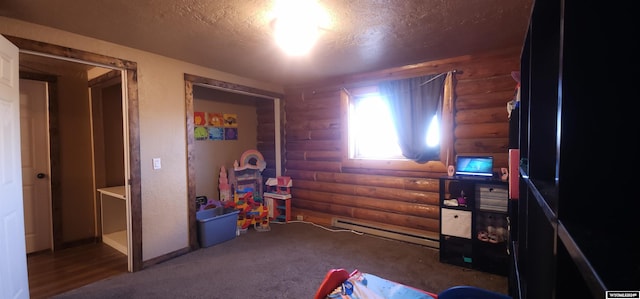 rec room featuring log walls, a textured ceiling, and a baseboard radiator