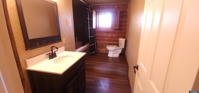 bathroom featuring vanity, toilet, and wood-type flooring