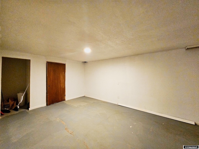 unfurnished room featuring a textured ceiling and concrete flooring