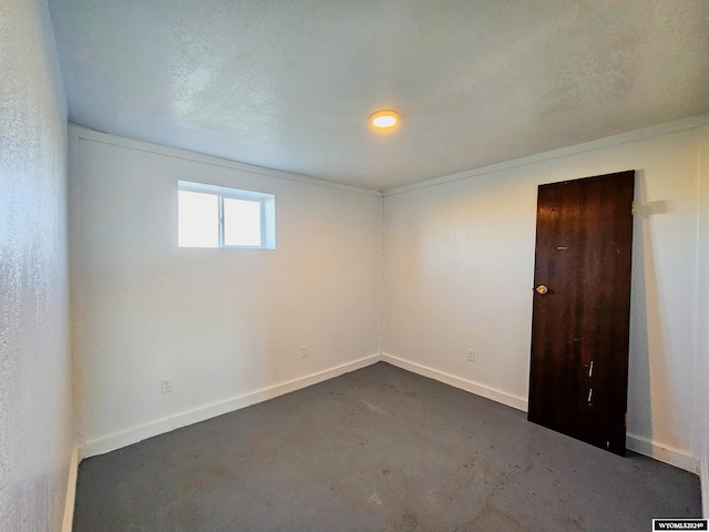 unfurnished room featuring a textured ceiling