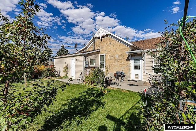 back of property featuring a yard and a patio area