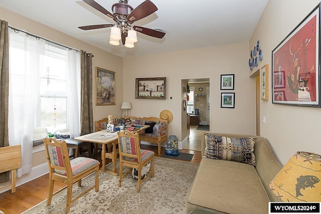 dining space with light hardwood / wood-style flooring and ceiling fan