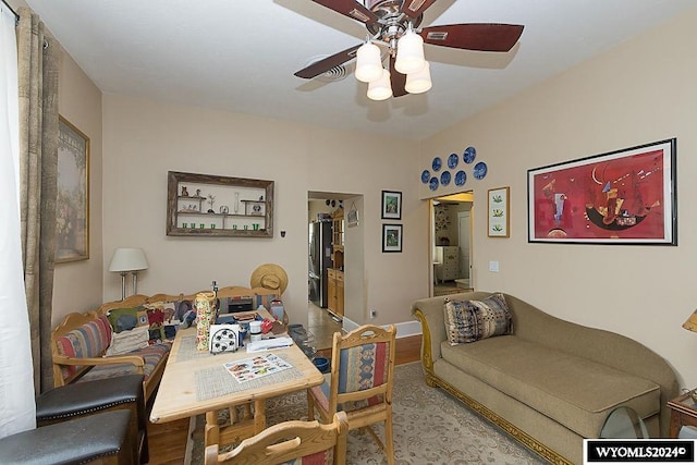 dining area with light hardwood / wood-style flooring and ceiling fan