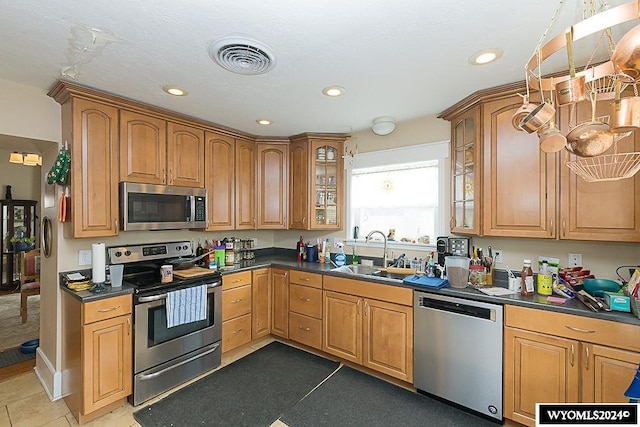 kitchen featuring appliances with stainless steel finishes, sink, and tile patterned flooring