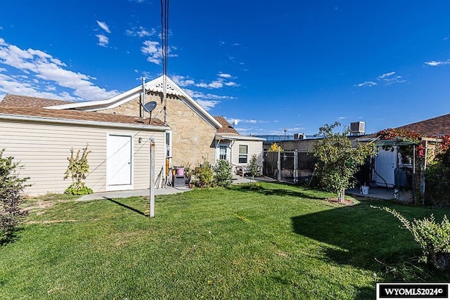 back of property with a yard and cooling unit