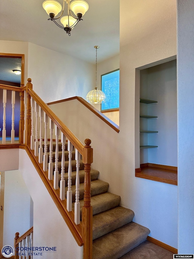 staircase featuring built in features, carpet flooring, and baseboards