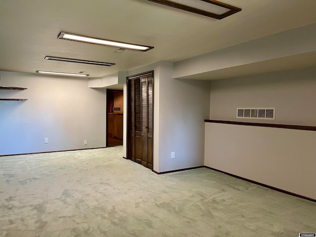 basement featuring light colored carpet