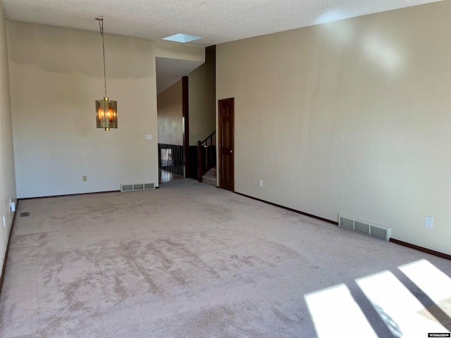 empty room featuring a textured ceiling and carpet floors