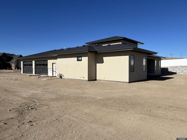 6060 Rivers Gate, Casper, WY 82604 - view of side of home with a garage and stucco siding