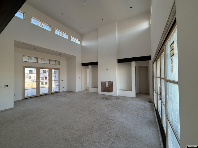 6060 Rivers Gate, Casper, WY 82604 - unfurnished living room with a towering ceiling and french doors