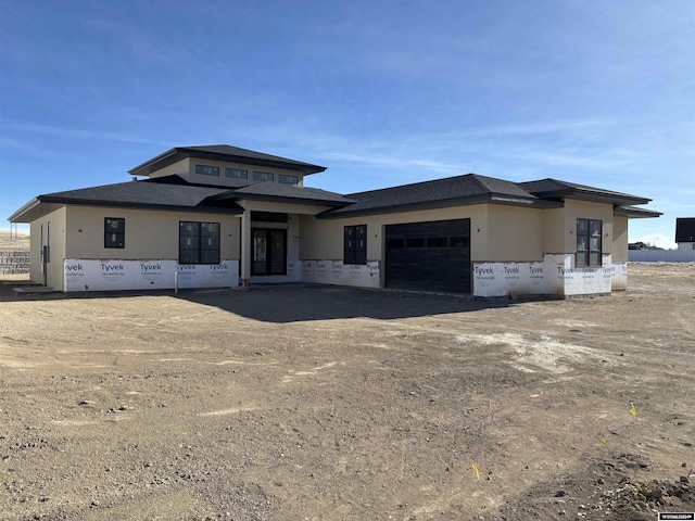 6060 Rivers Gate, Casper, WY 82604 - view of front facade featuring an attached garage, driveway, and stucco siding
