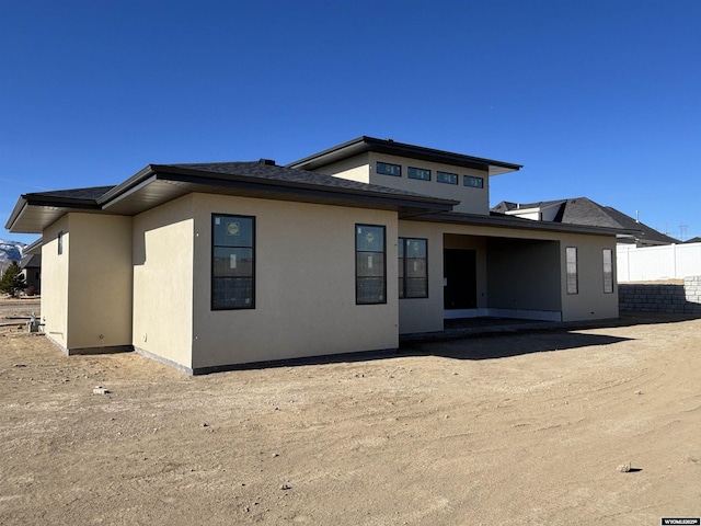 6060 Rivers Gate, Casper, WY 82604 - back of property featuring stucco siding and a shingled roof
