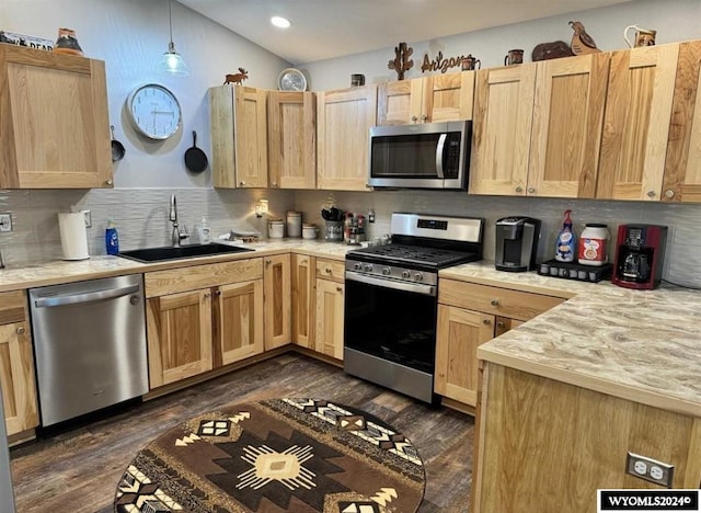 kitchen with dark hardwood / wood-style floors, sink, decorative light fixtures, light brown cabinetry, and appliances with stainless steel finishes