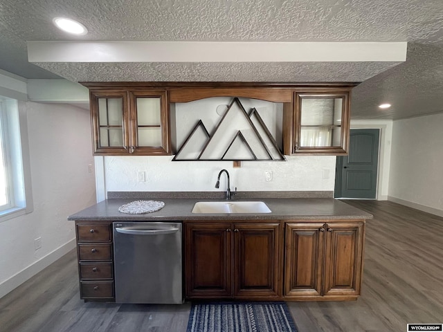 kitchen featuring sink, dishwasher, dark hardwood / wood-style floors, and a textured ceiling