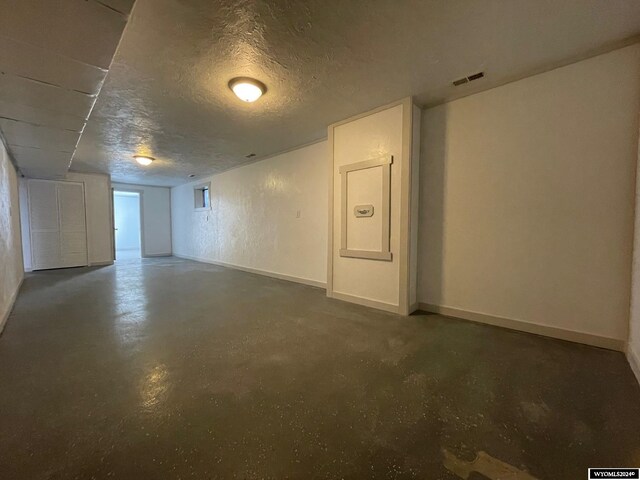 basement featuring a textured ceiling