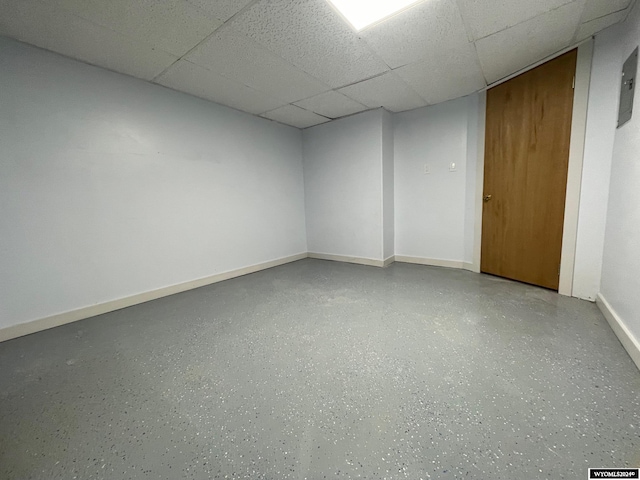 basement with a paneled ceiling