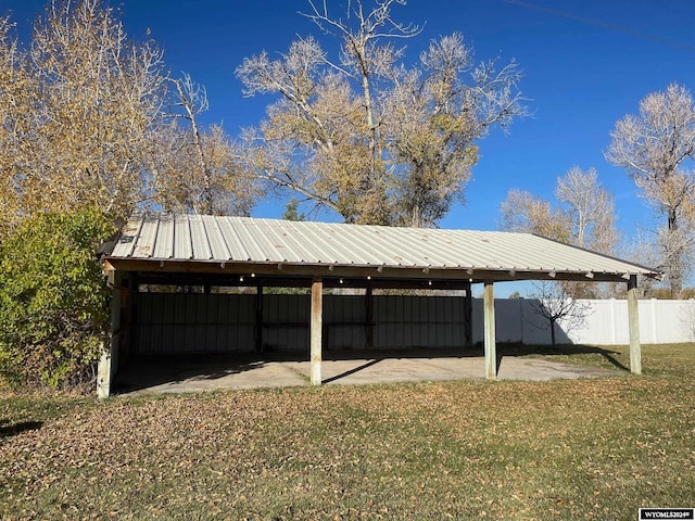 exterior space featuring a yard and a carport