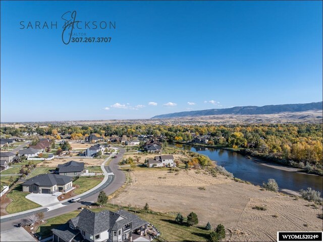 birds eye view of property featuring a water and mountain view