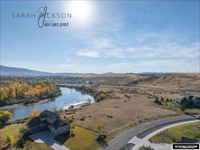 birds eye view of property featuring a water and mountain view