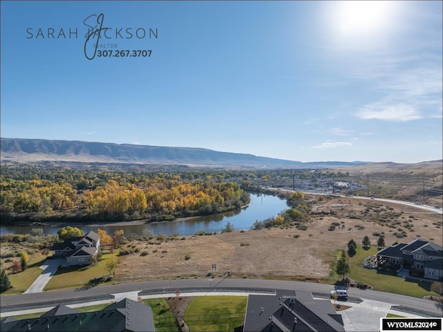 birds eye view of property featuring a water and mountain view