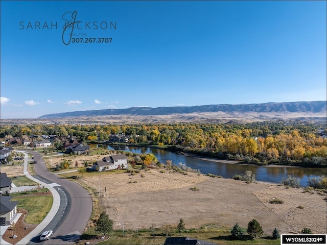 drone / aerial view featuring a water and mountain view