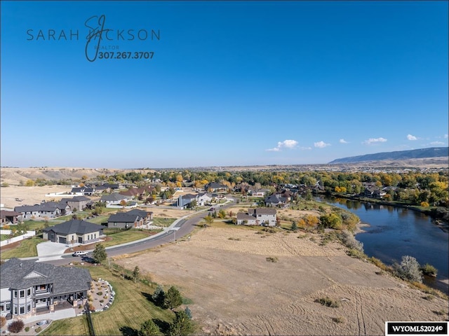 birds eye view of property with a water and mountain view