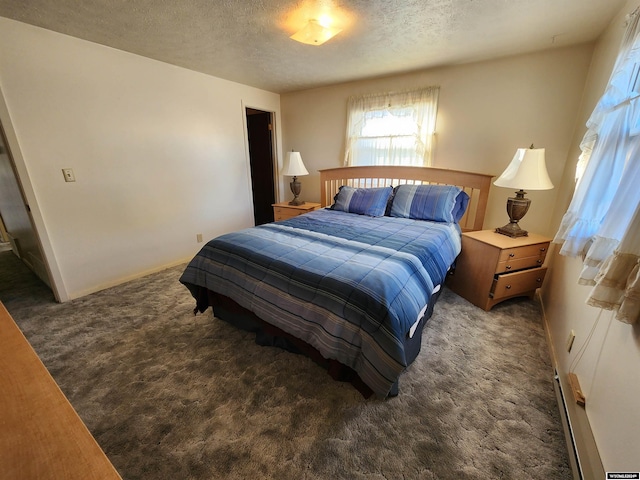 bedroom with a baseboard radiator, dark carpet, and a textured ceiling