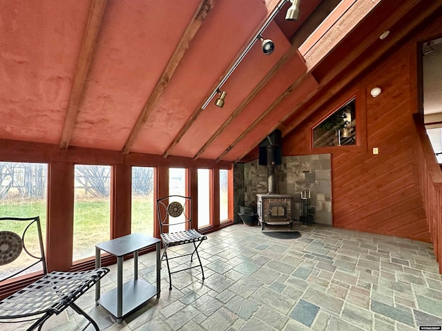 36 County Road 211, Riverside, WY 82325 - sunroom featuring lofted ceiling with beams and a wood stove