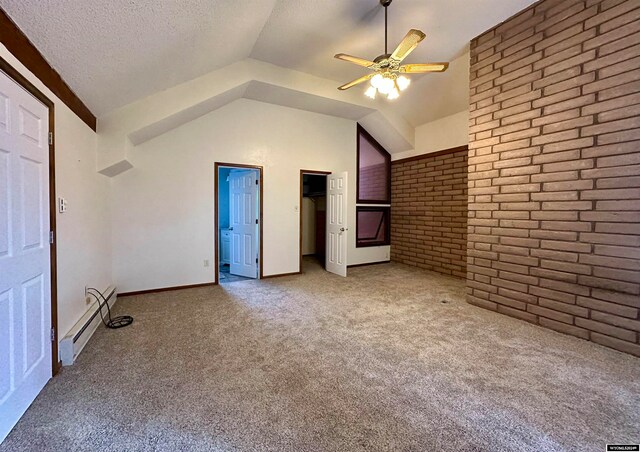 36 County Road 211, Riverside, WY 82325 - unfurnished bedroom featuring ceiling fan, a textured ceiling, carpet flooring, vaulted ceiling, and brick wall