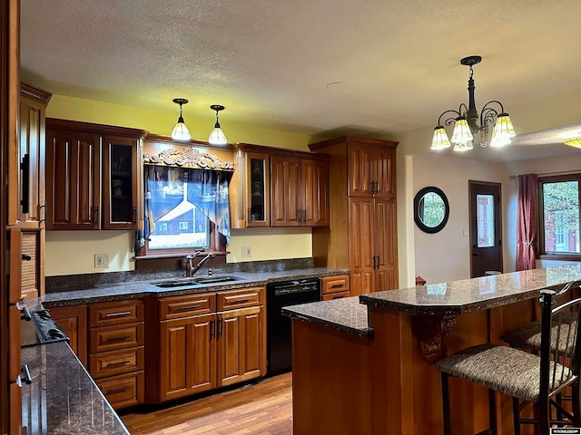 36 County Road 211, Riverside, WY 82325 - kitchen with black dishwasher, sink, a textured ceiling, and light hardwood / wood-style floors