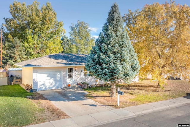 view of front of home with a front yard and a garage