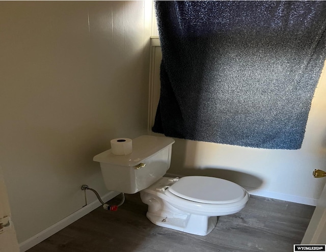 bathroom with toilet and hardwood / wood-style floors