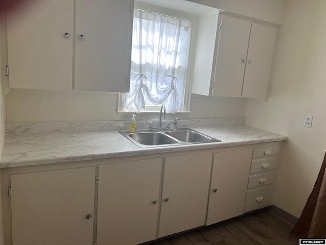 kitchen with sink, white cabinets, and dark hardwood / wood-style floors