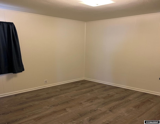 unfurnished room featuring dark hardwood / wood-style floors