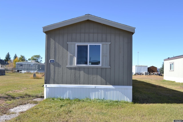 view of side of home with a yard