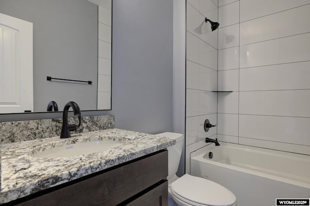 bathroom featuring toilet, vanity, and bathing tub / shower combination